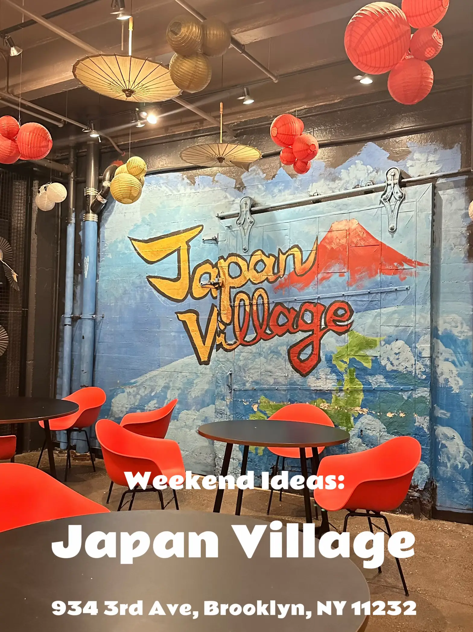  A restaurant with a mural of a beach and the words "Japan Village" on the wall.