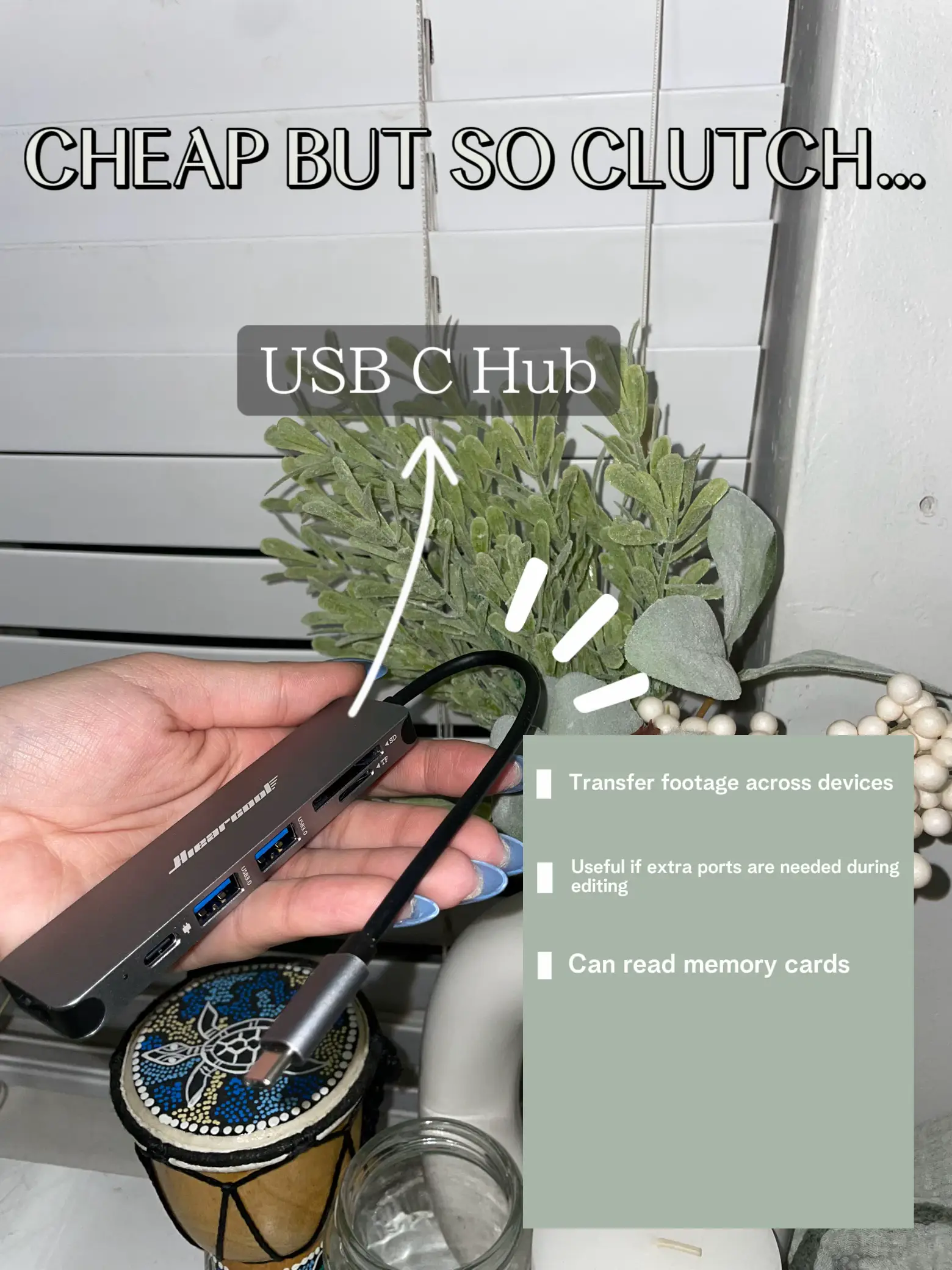  A hand holding a cell phone with a USB C Hub.