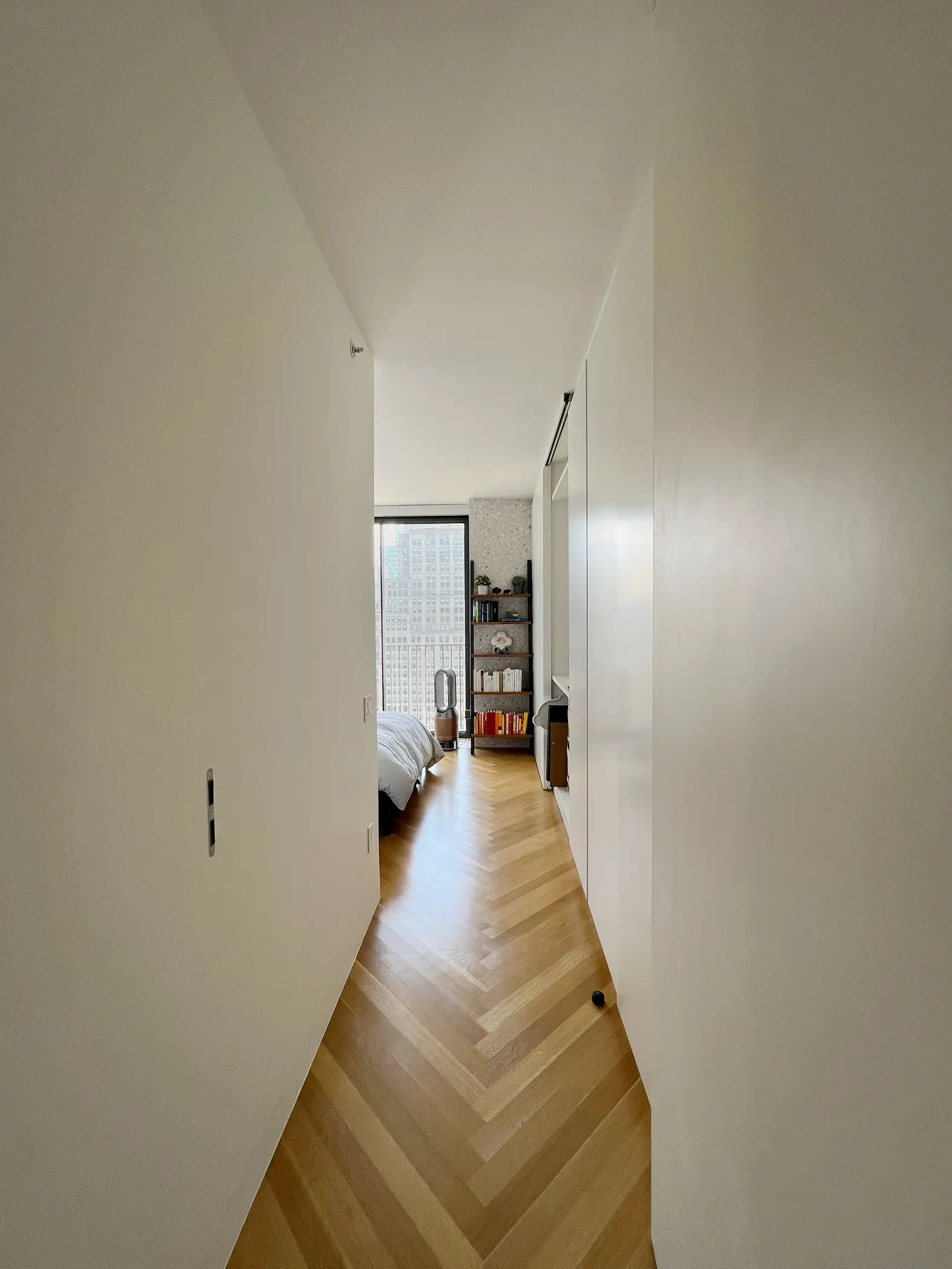  A hallway with a white door and a light on.
