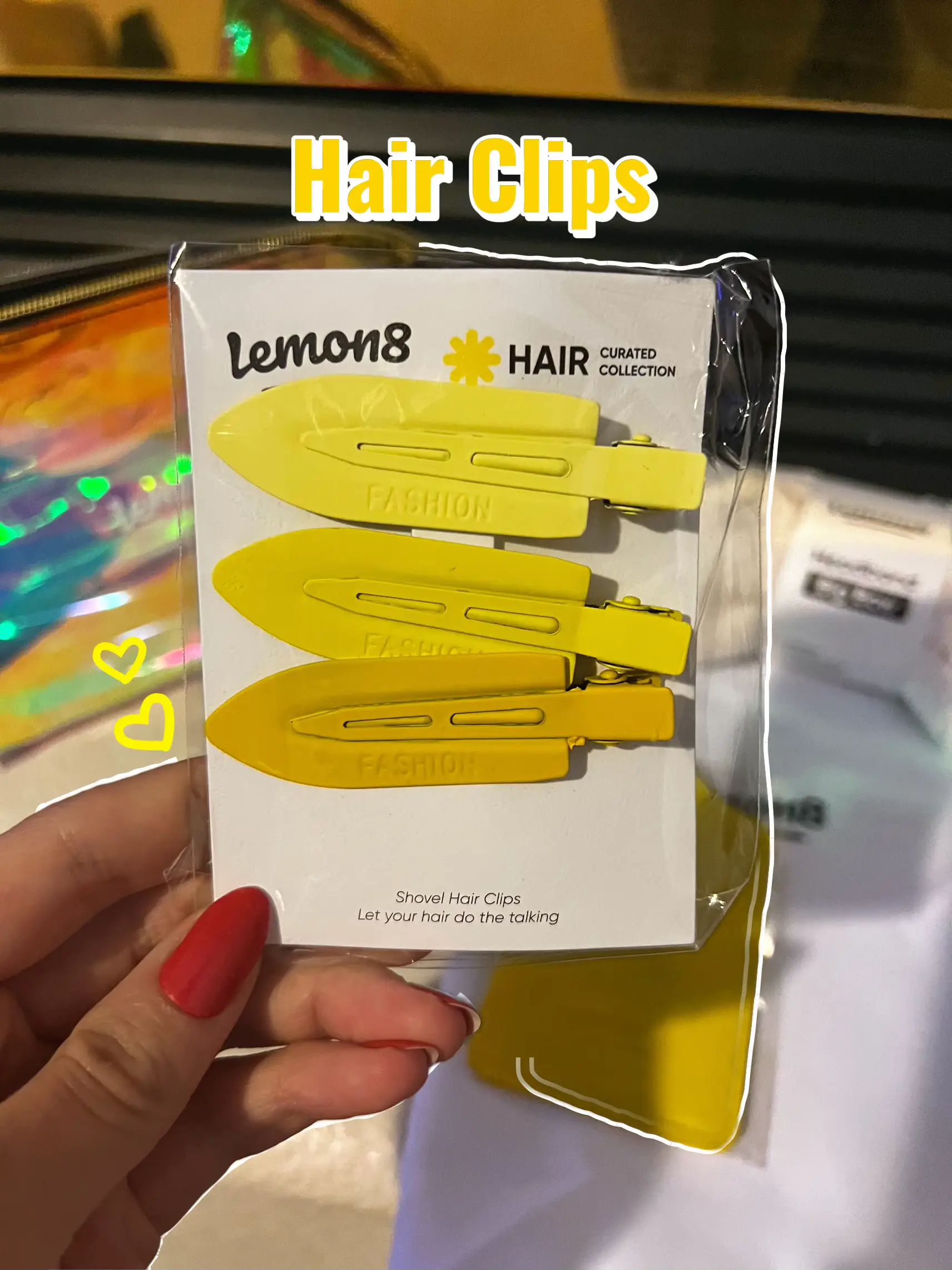  A person is holding a box of hair clips by Lemon8.