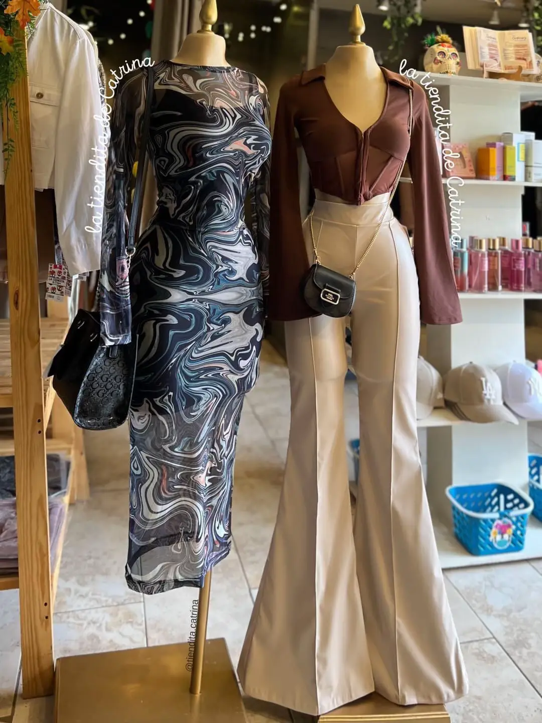  Two mannequins wearing dresses in a store.