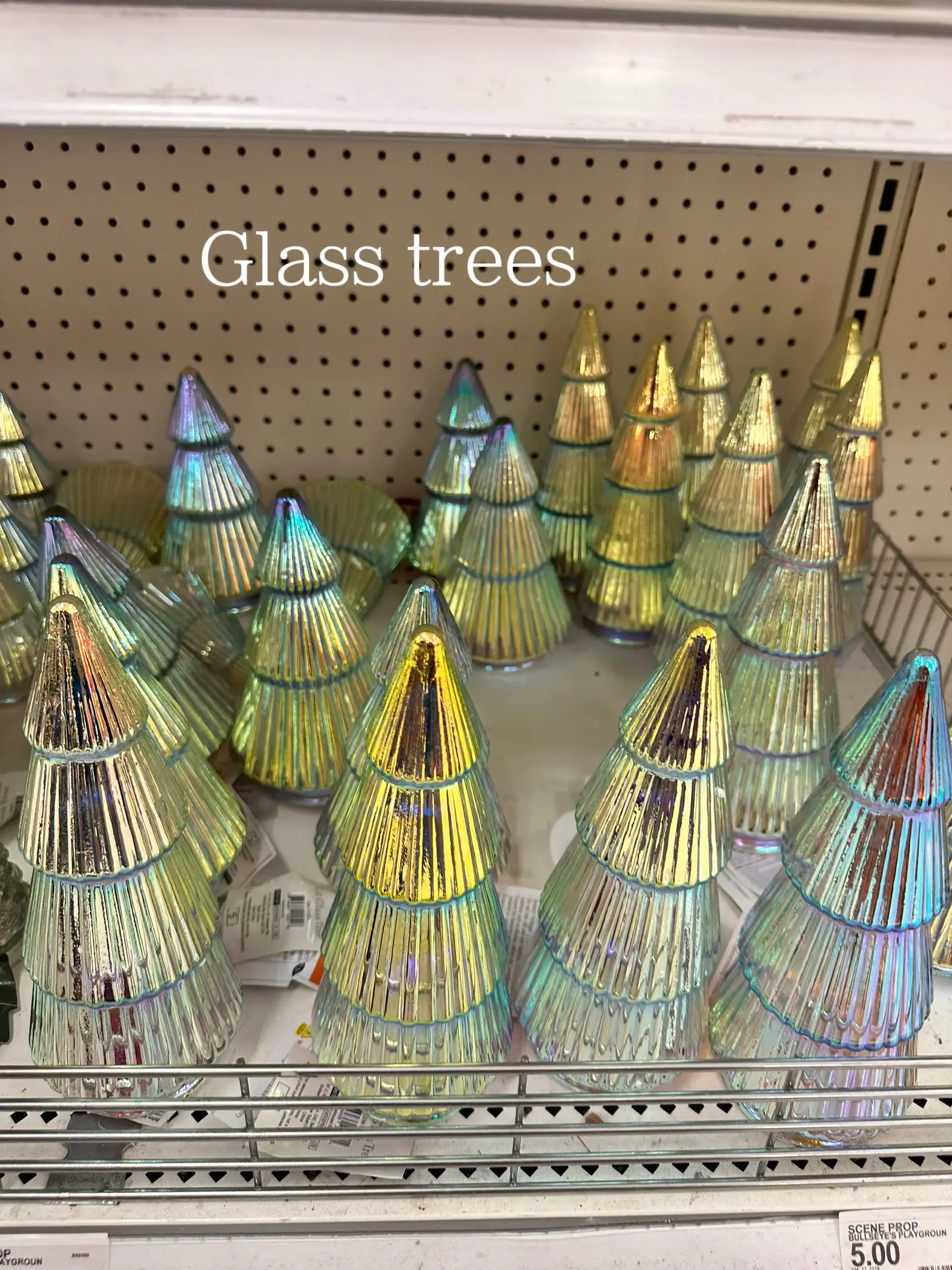  A shelf with a bunch of glass trees on it.