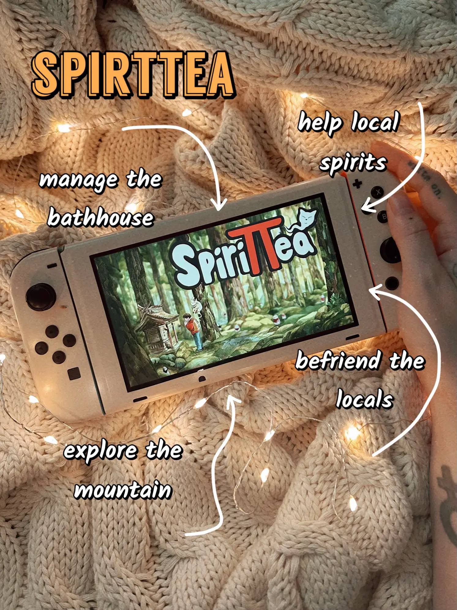  A hand holding a video game controller with a screen that says "spirittea" on it.