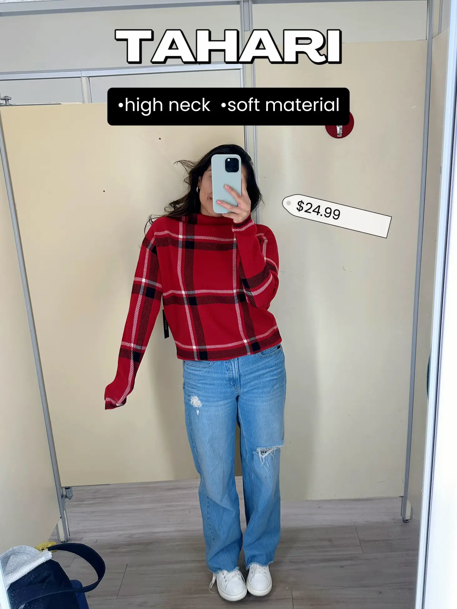  A woman in a red and white checkered shirt is taking a selfie in a mirror.