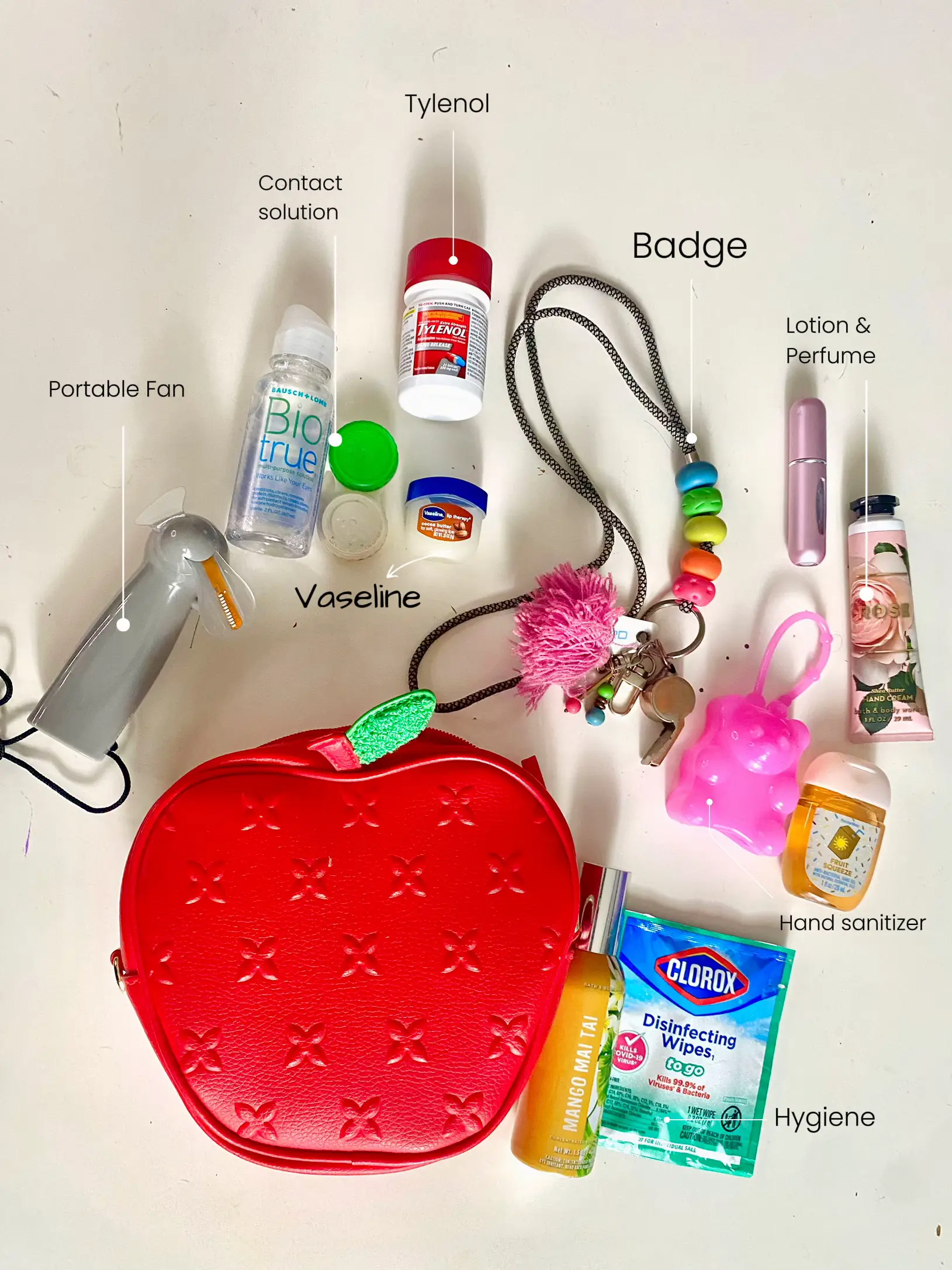  A collection of personal care items including a bottle of hand sanitizer and a badge