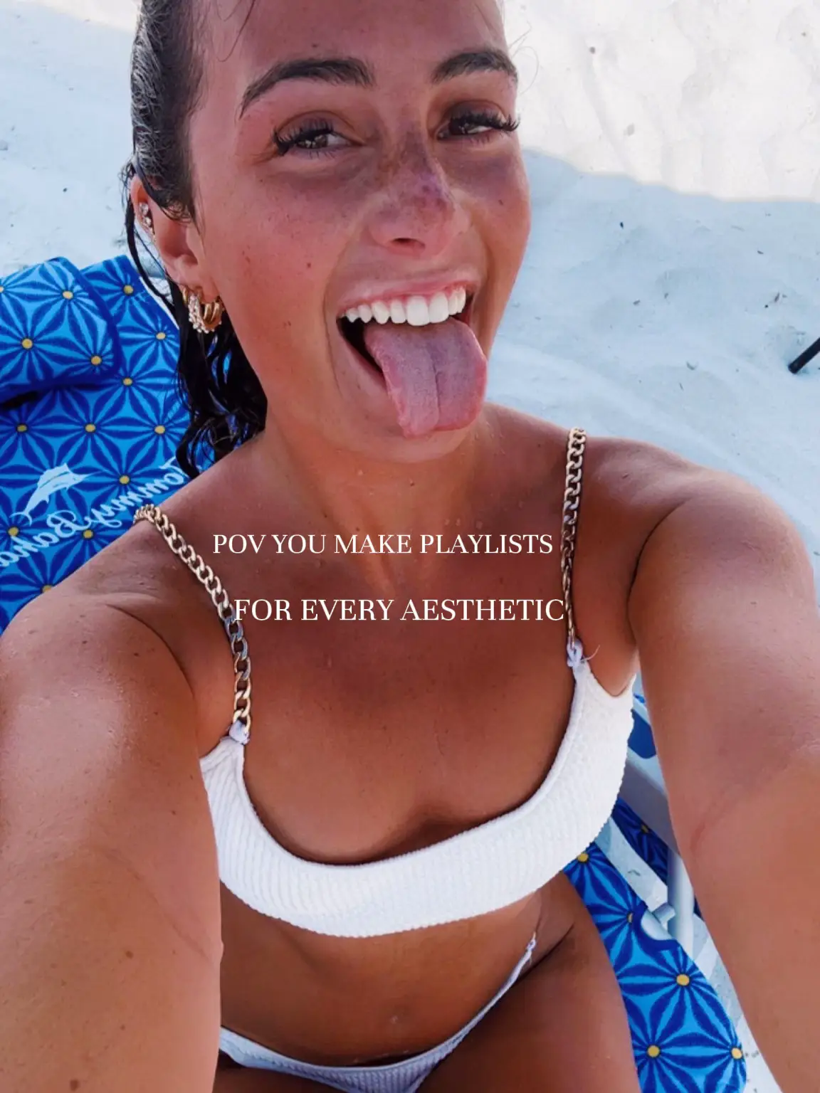  A woman in a white bikini is making a playlist for every aesthetic.