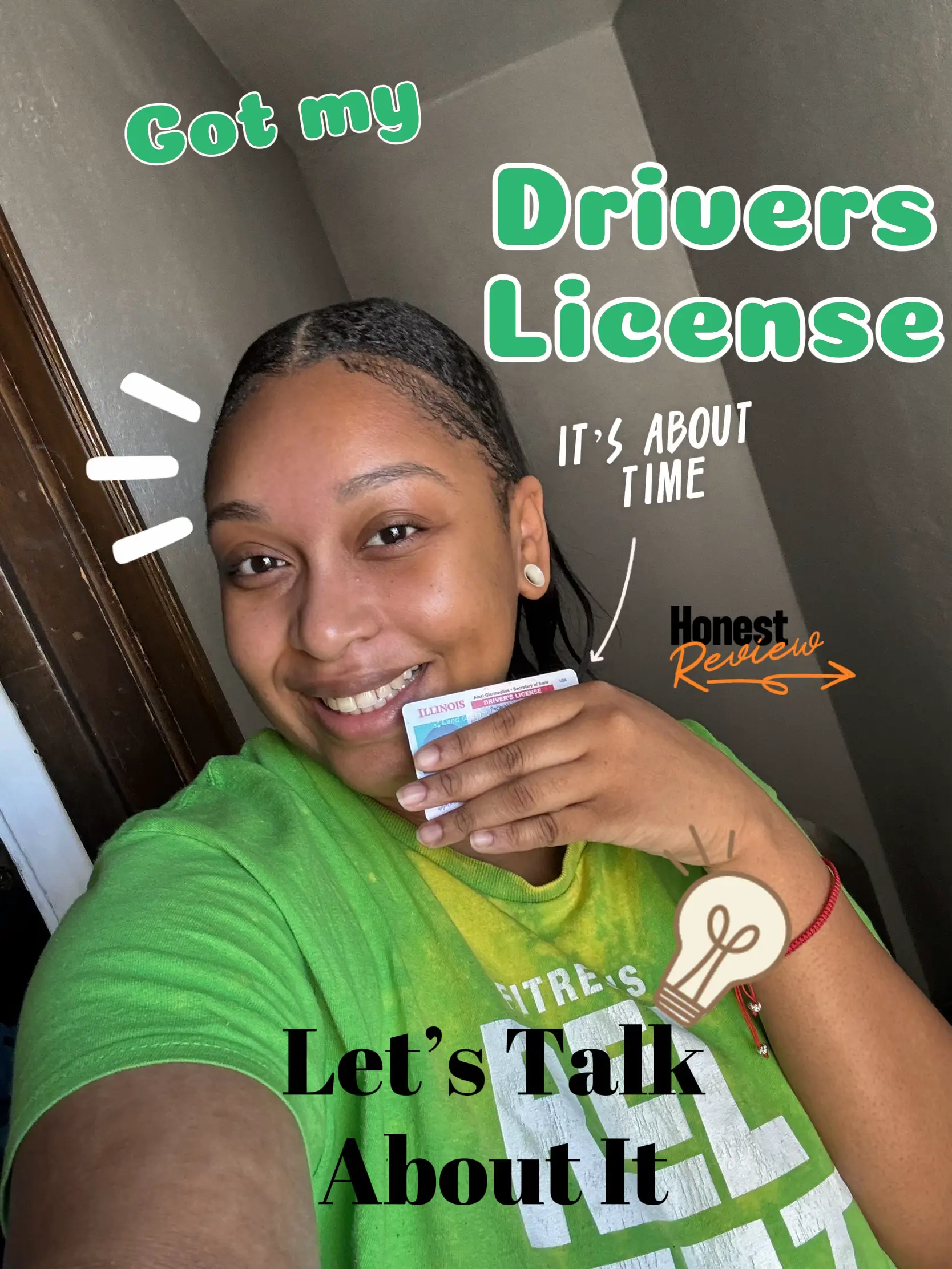  A woman is smiling and holding a drivers license.