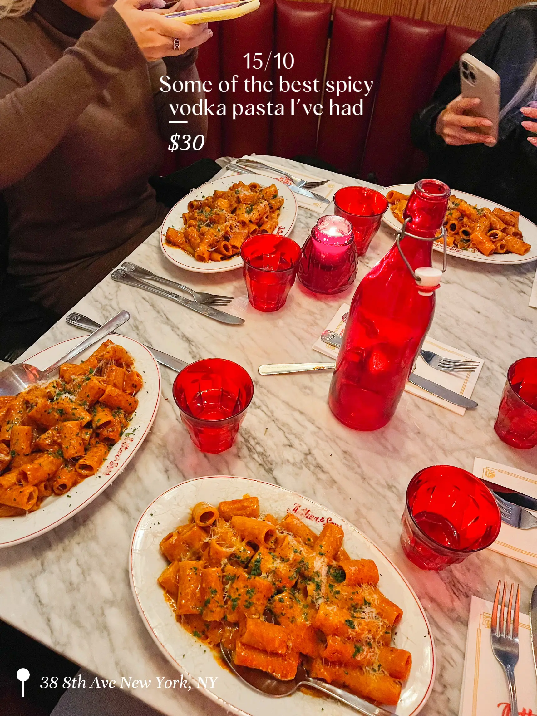  A table with a plate of spicy vodka pasta and a bottle of vodka.
