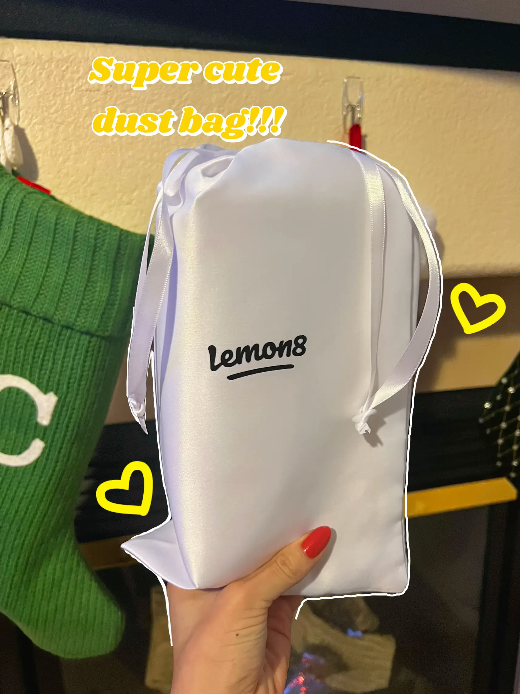  A person is holding a white bag with a lemon on it.
