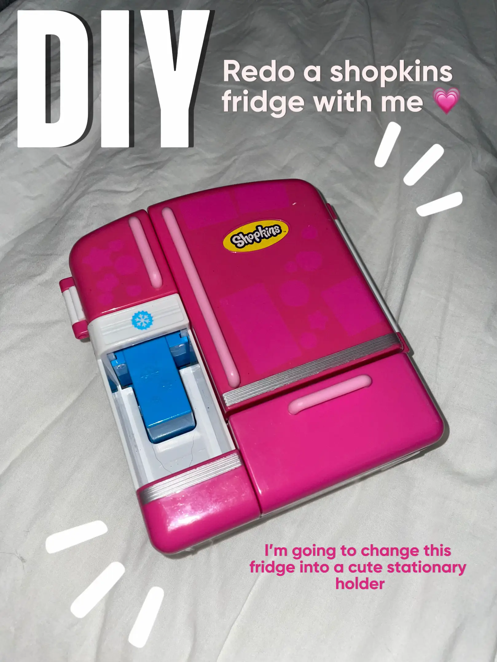 A pink fridge with a white background.