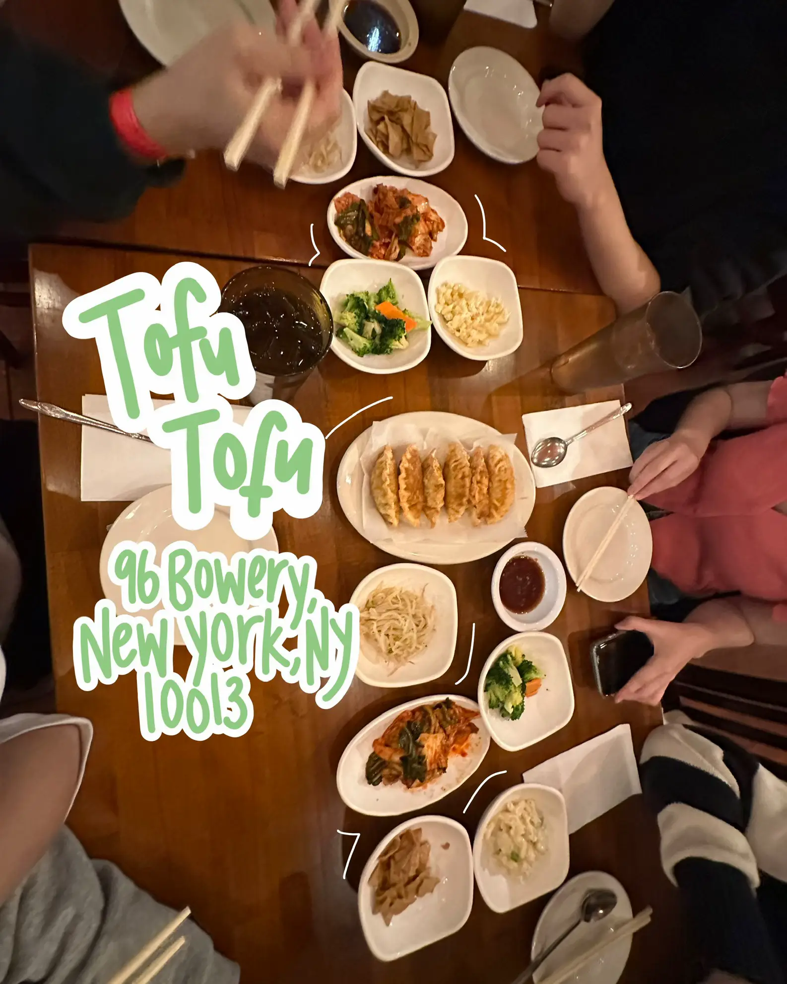  A group of people are sitting at a table with plates of food.