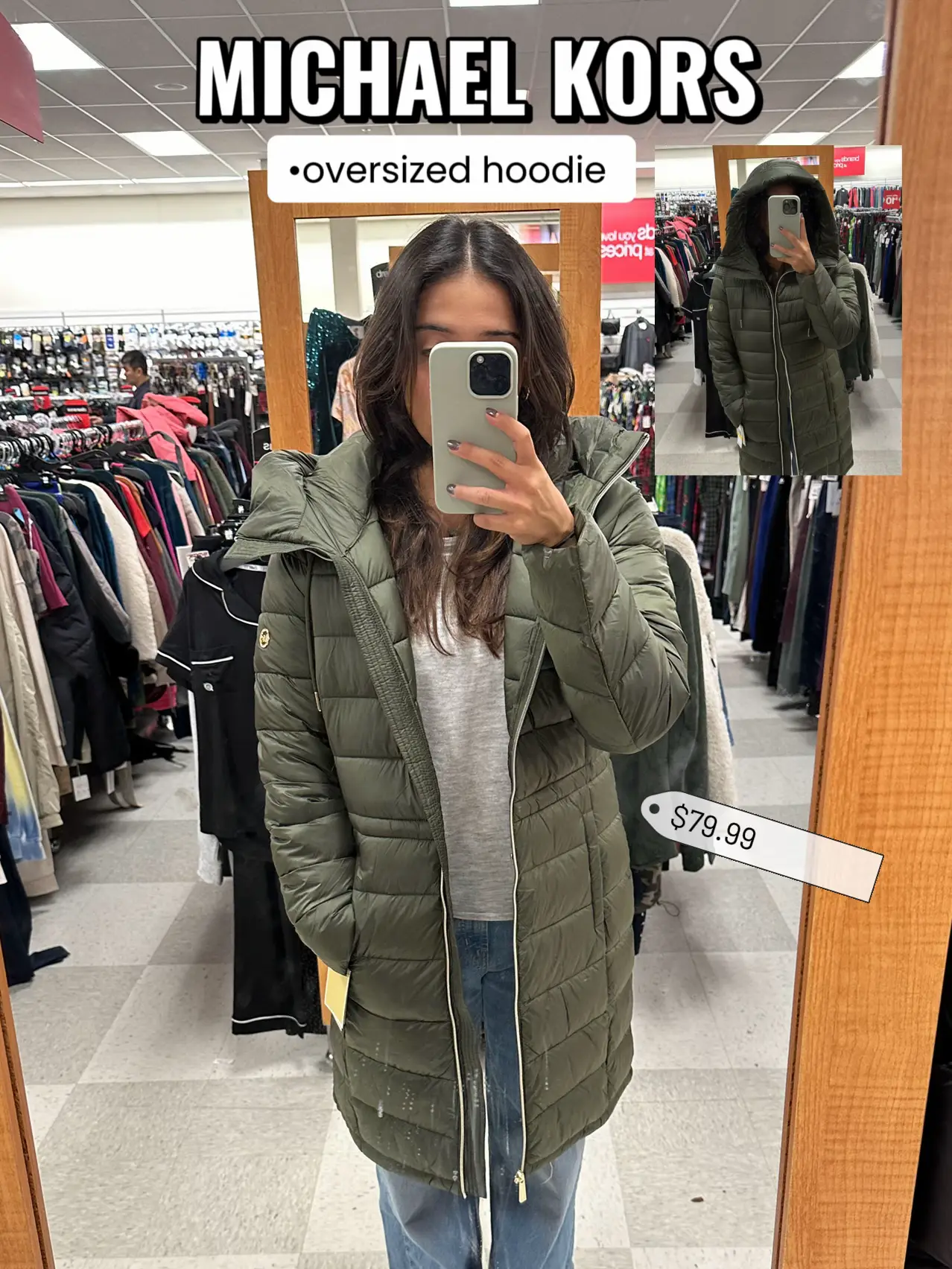  A woman in a green Michael Kors hoodie is taking a selfie in a store.