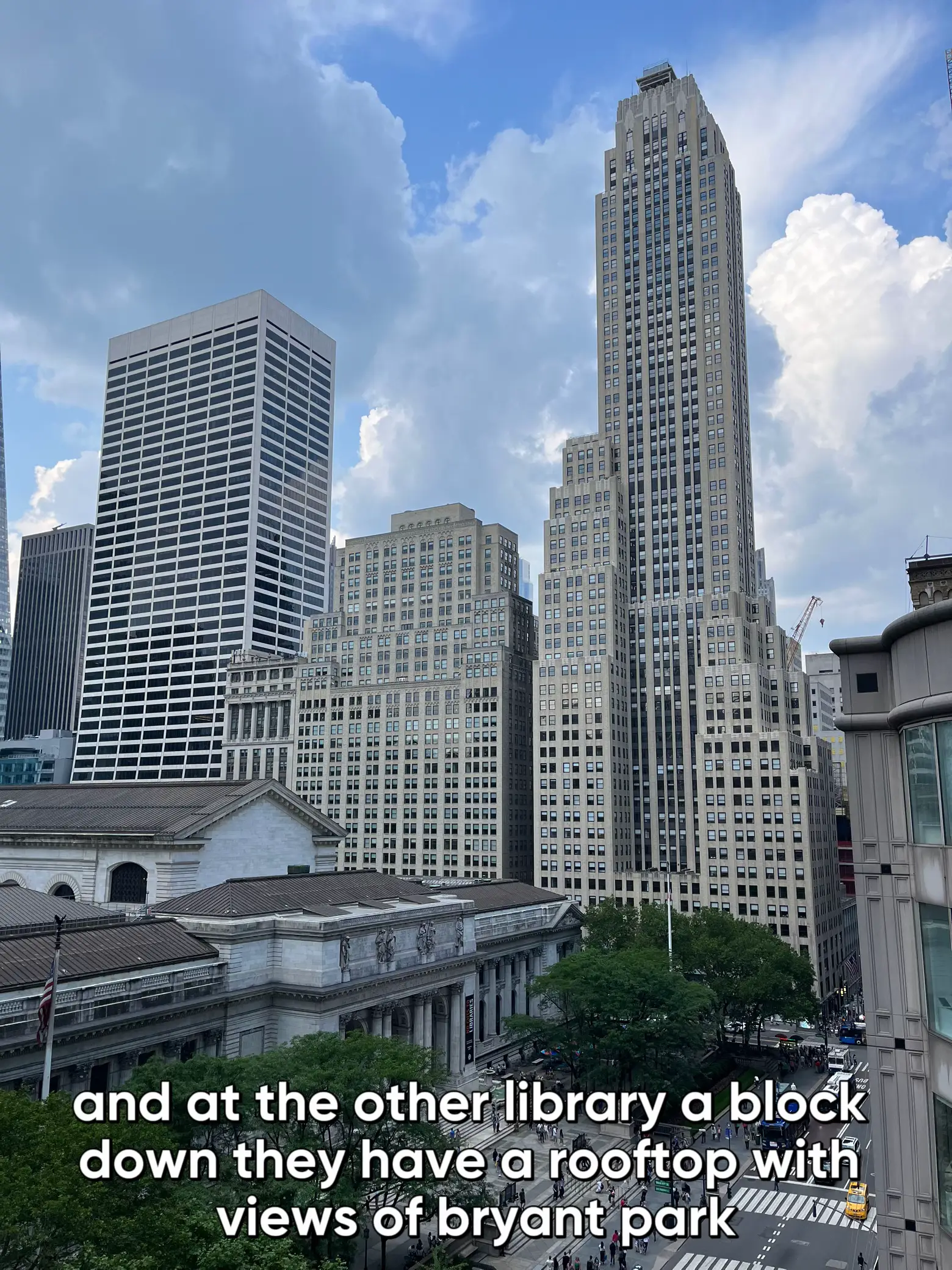  The image shows a city skyline with a large building in the foreground. The building has a sign on top that says "and at the other library