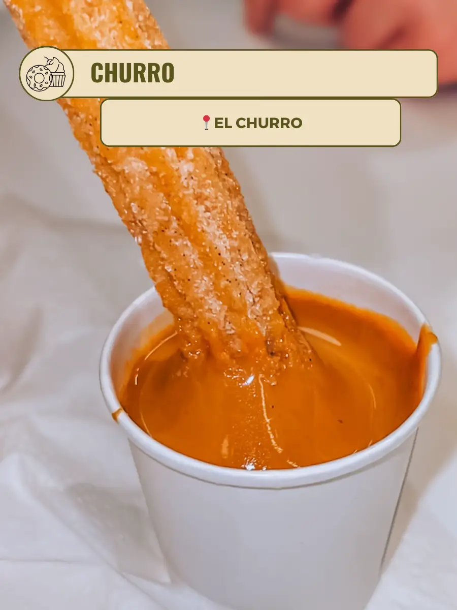  A cup of coffee with a churro in it.