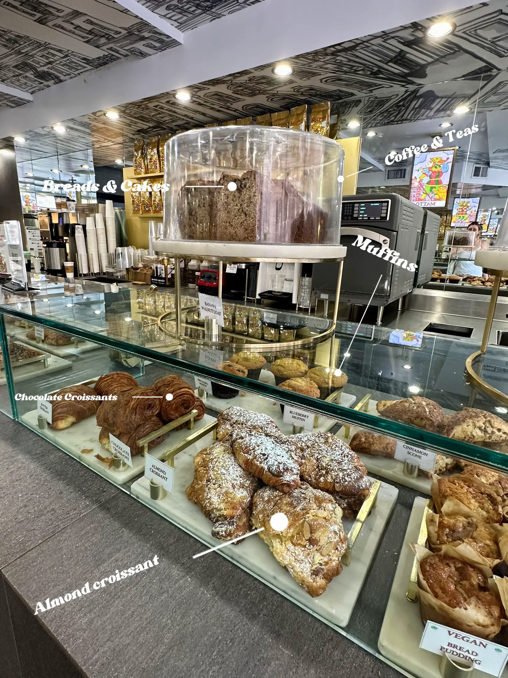  A display of pastries including croissants and almond croissants.
