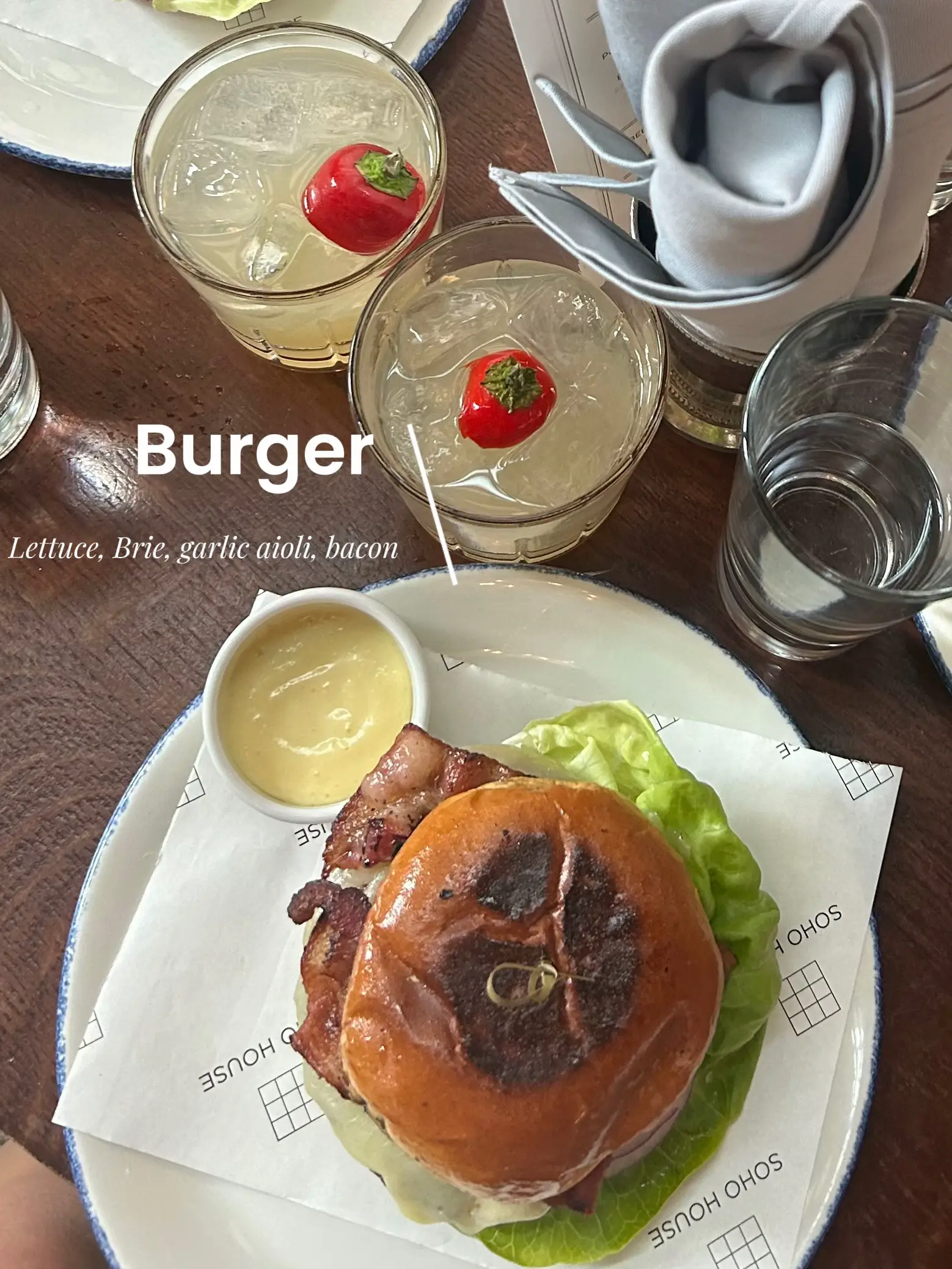  A close up of a plate with a burger and a drink.
