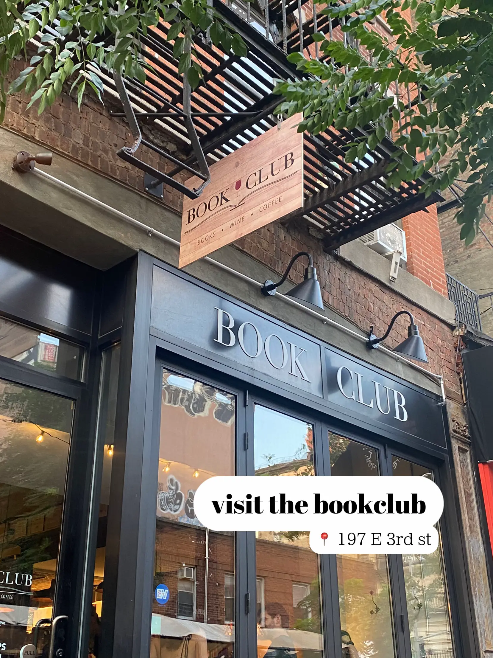  A storefront with a sign that says "visit the bookclub".
