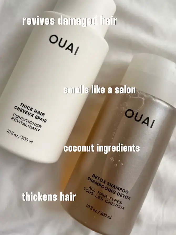  Two bottles of Ouai hair care product are displayed on a table.