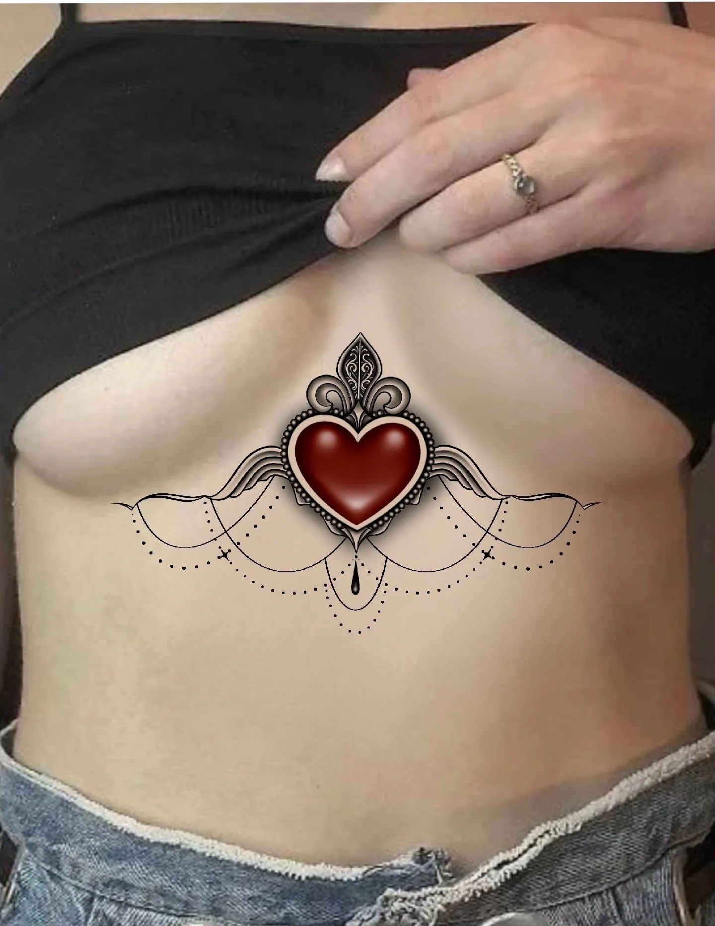 Minimalist red heart tattoo on the breast.