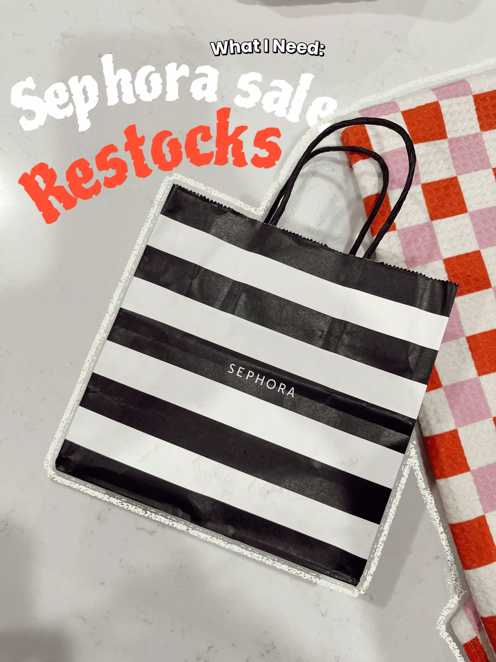  A black and white bag with a striped pattern and the word "Sephora" on it.
