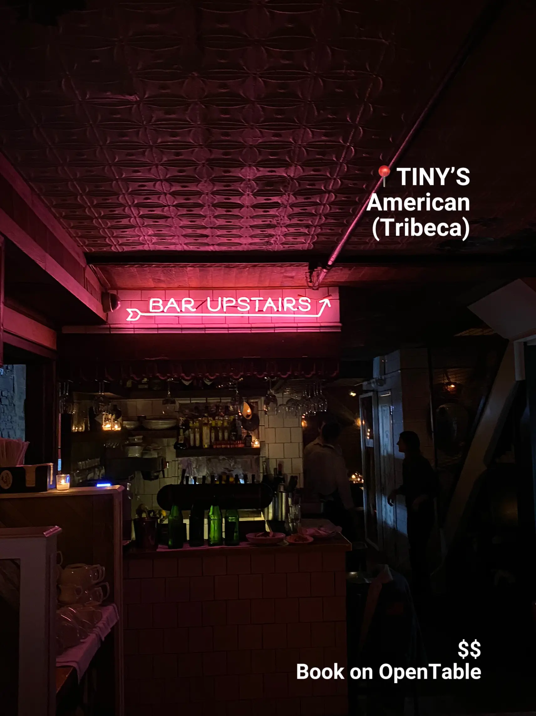  A bar with a neon sign that says "Bar Upstairs".