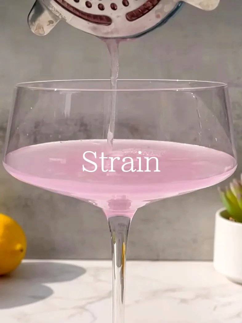  A glass of wine with the words " strain " written on it.