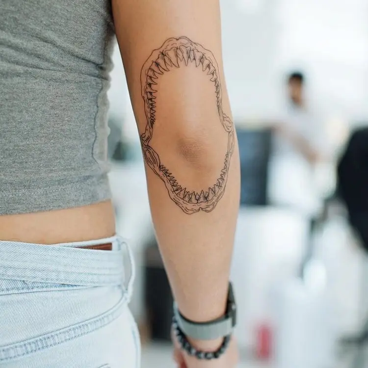  A person with a tattoo on their arm.