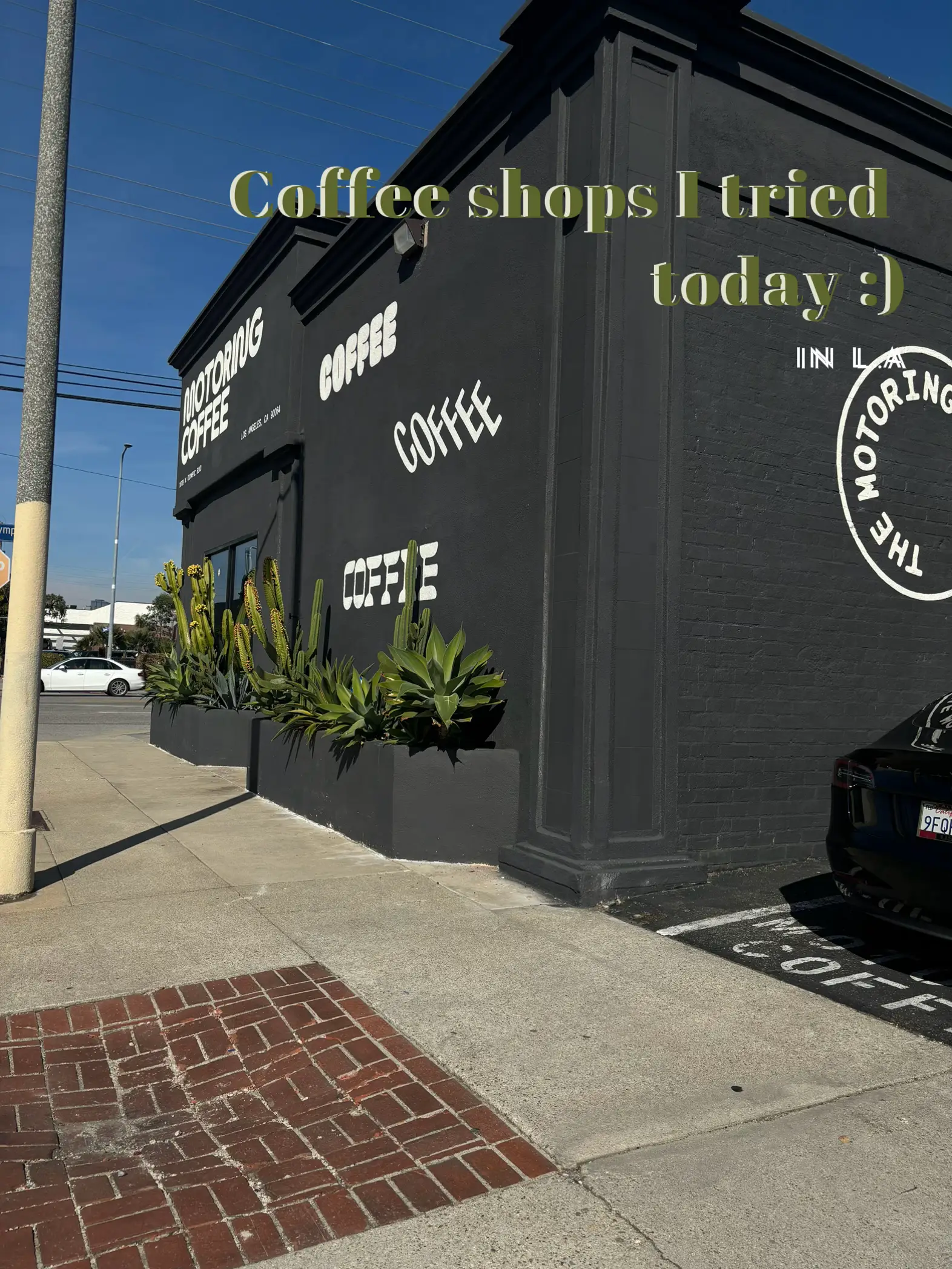  A black and white photo of a coffee shop with a car parked in front.