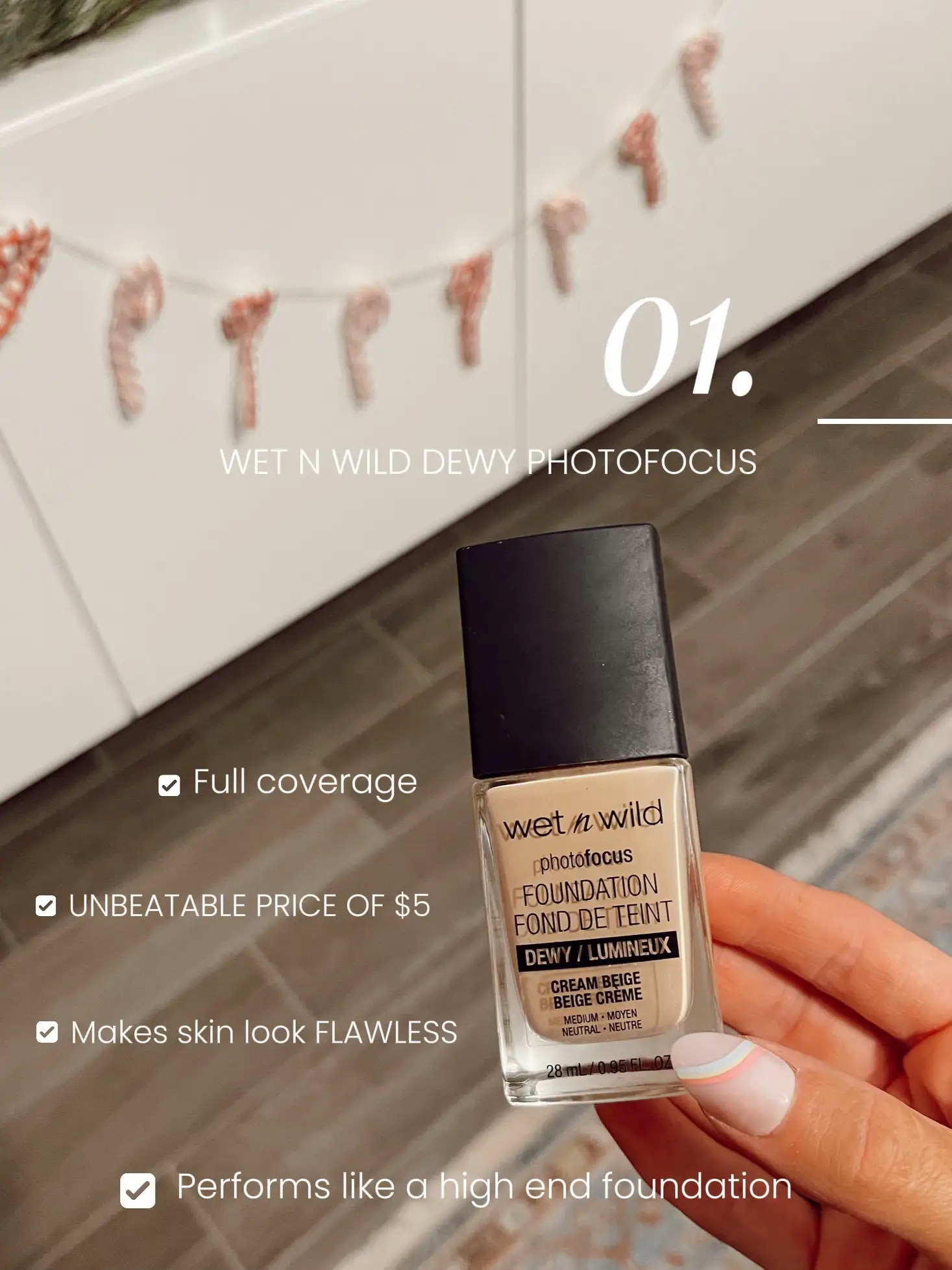  A bottle of Wet N Wild Photo Focus Foundation is being held by a person.