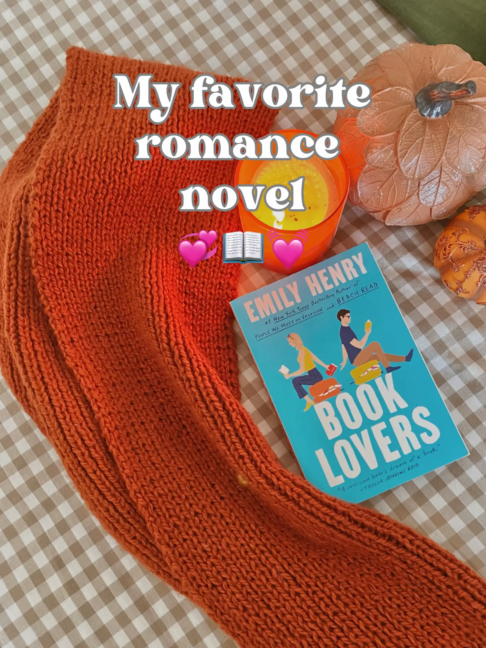  A book titled Book Lovers is laying on a blanket.