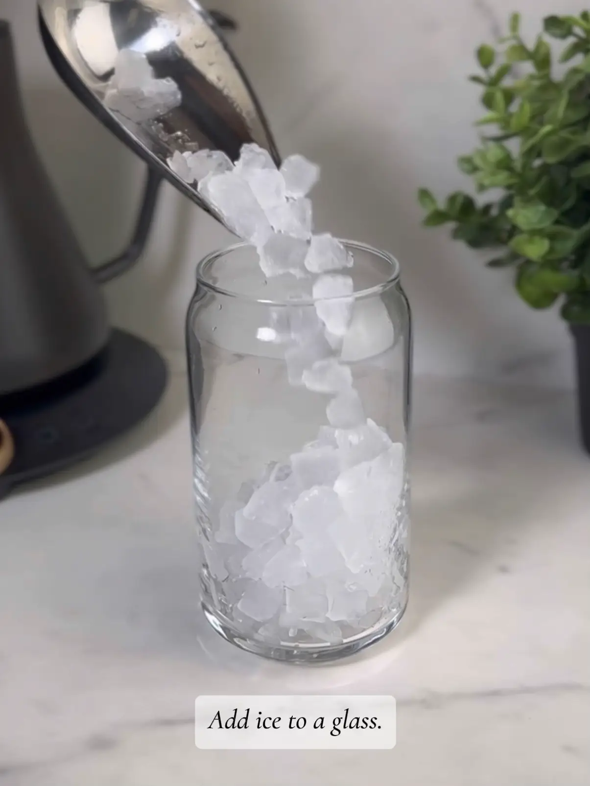  A glass with ice and a lemon in it.