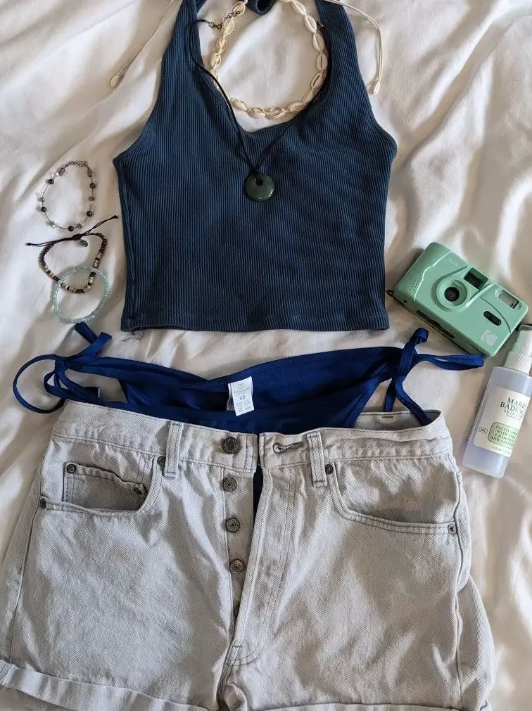 Music festival outfit idea: Cropped tee shirt, flannel shirt, ripped denim  shorts, stack of bracelets,…