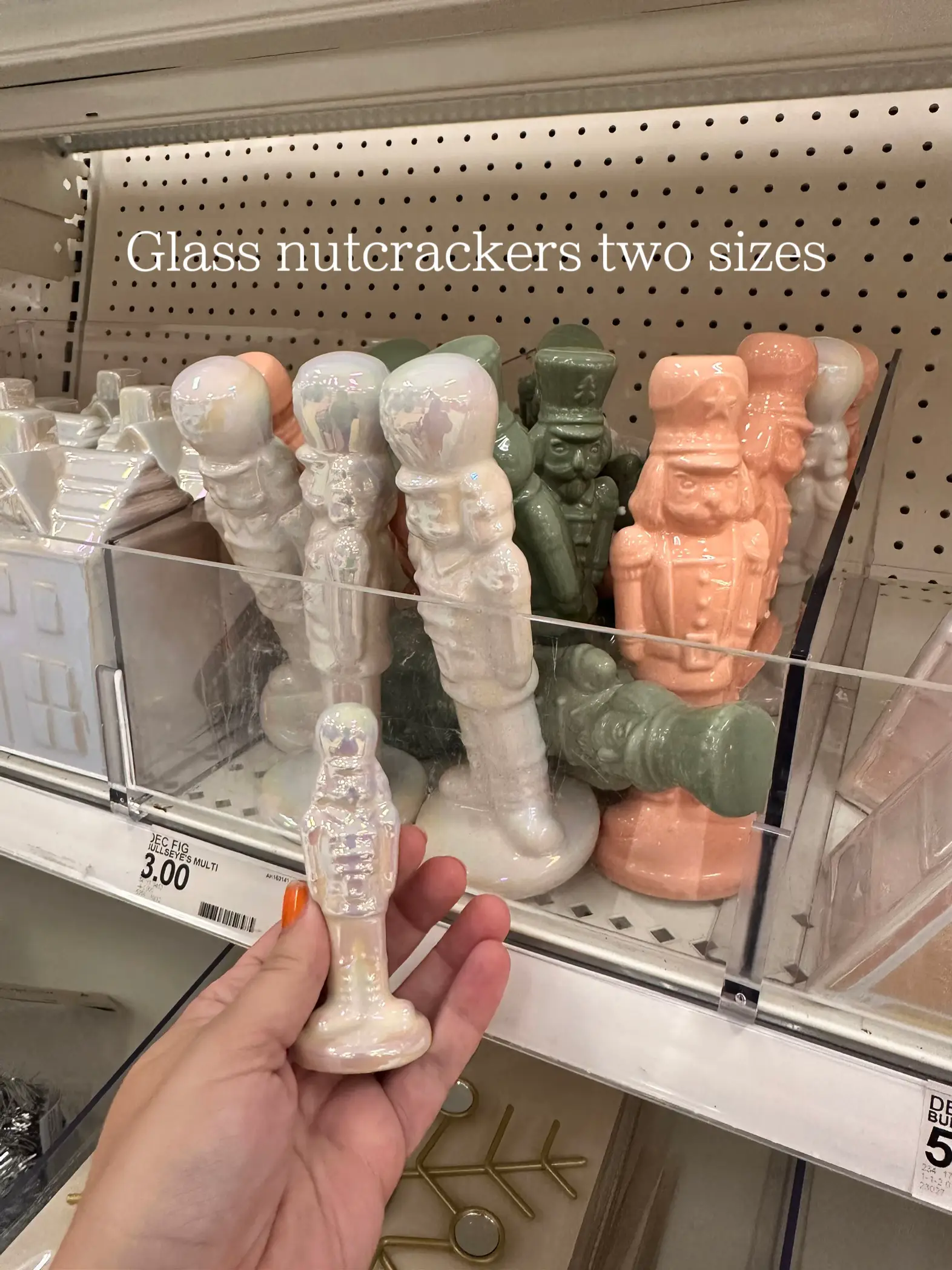  A person is holding a white nutcracker in their hand.