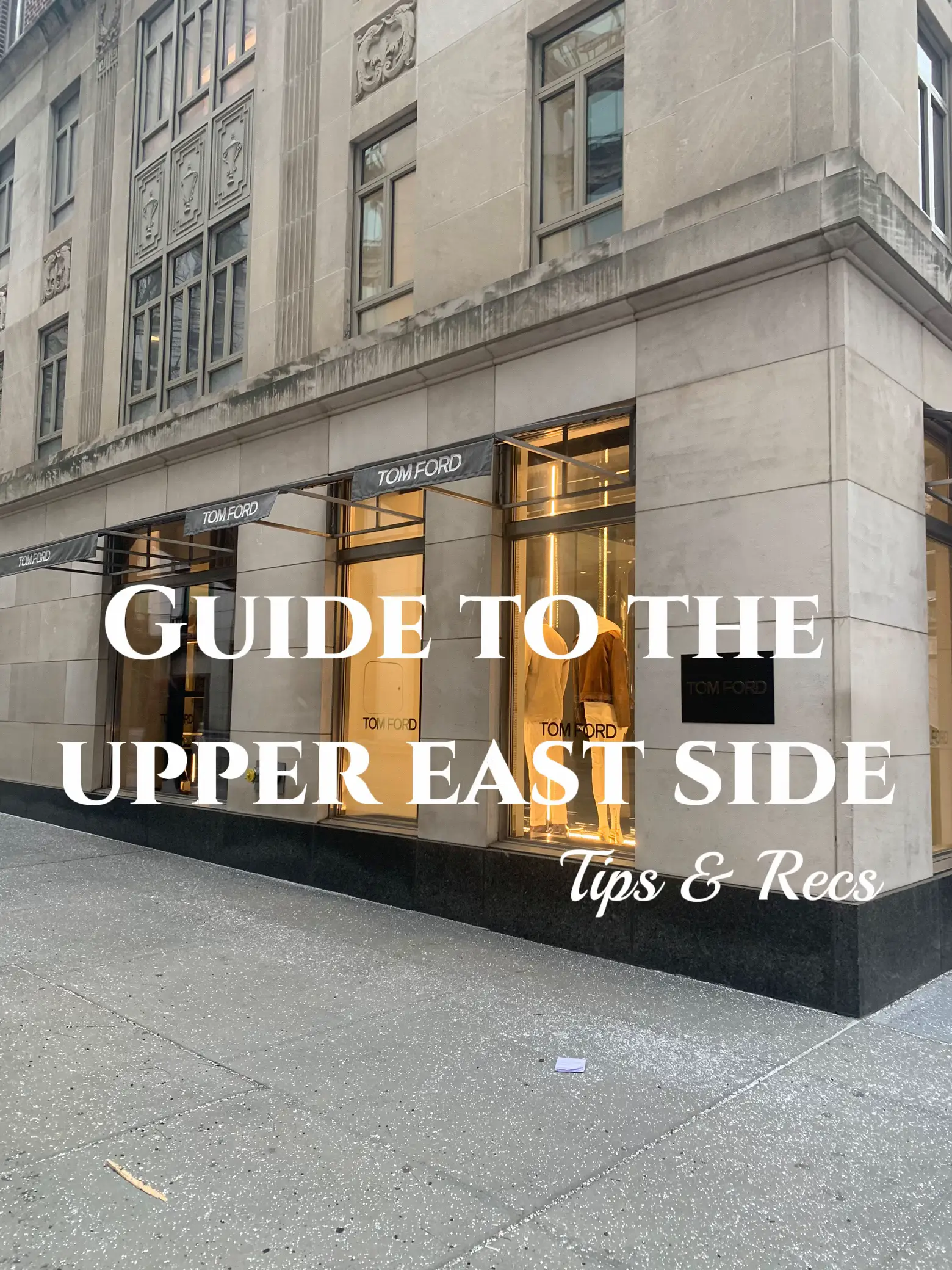  A white building with a sign that says "Guide to the Tom Ford Uppera East Side".