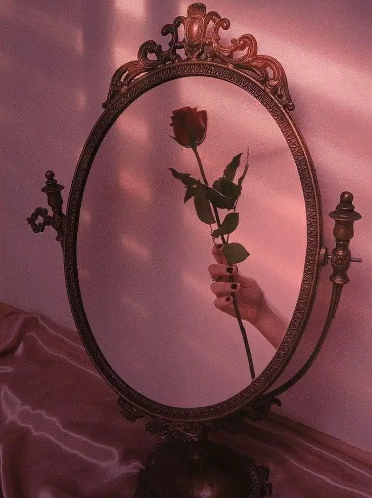  A mirror with a rose in it.