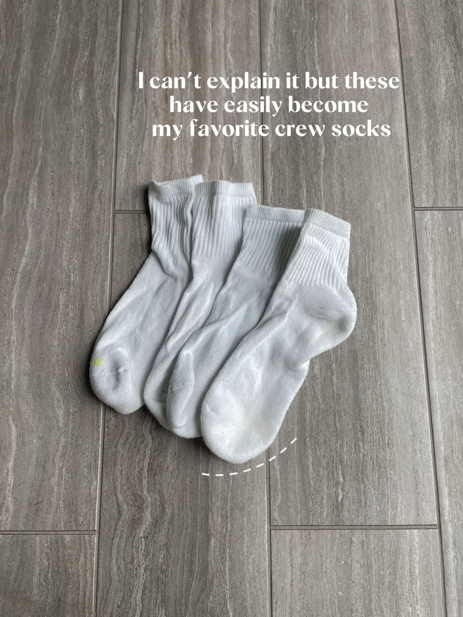  A pair of white socks with a green design.