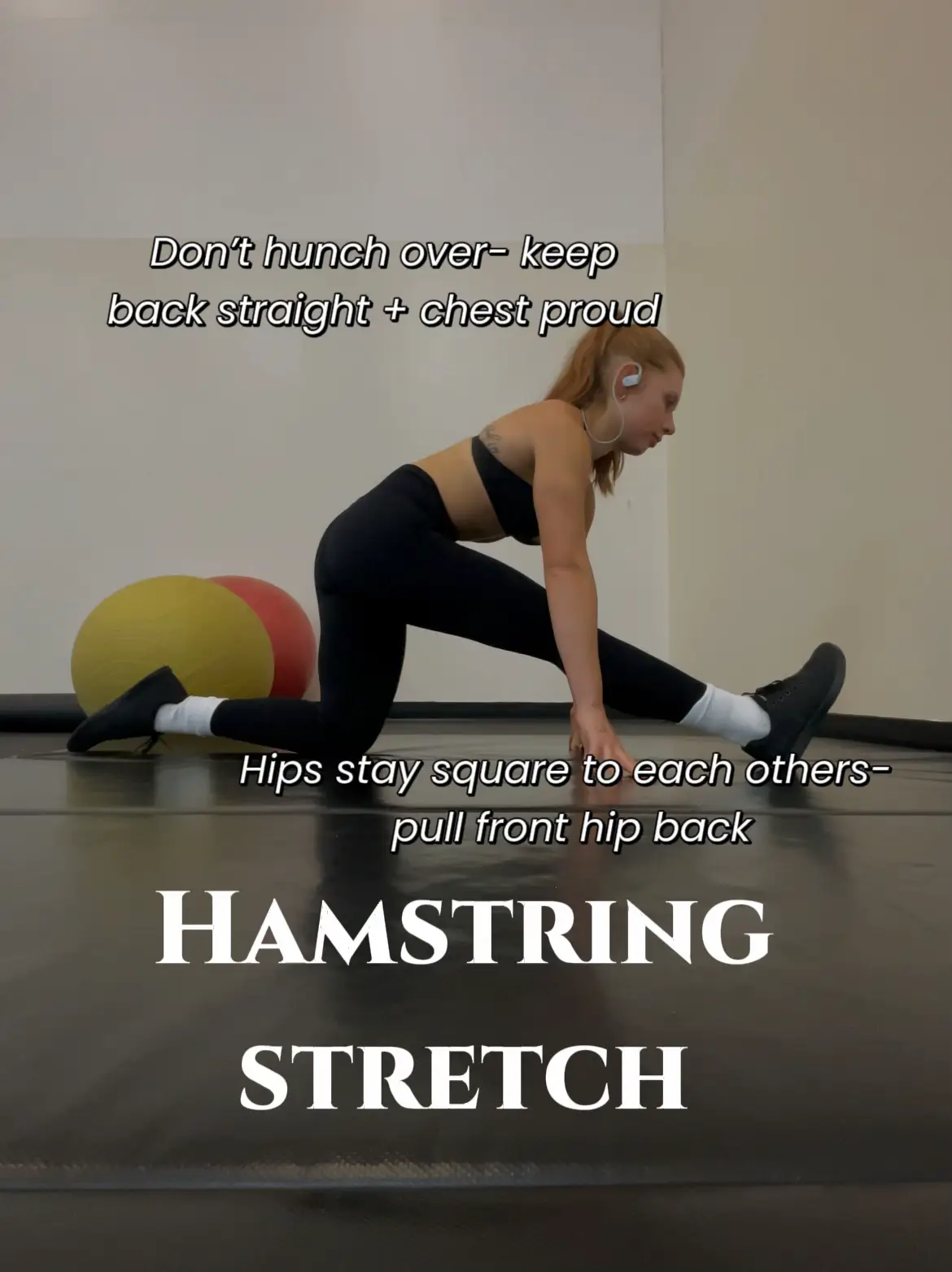  A woman is doing a hamstring stretch.