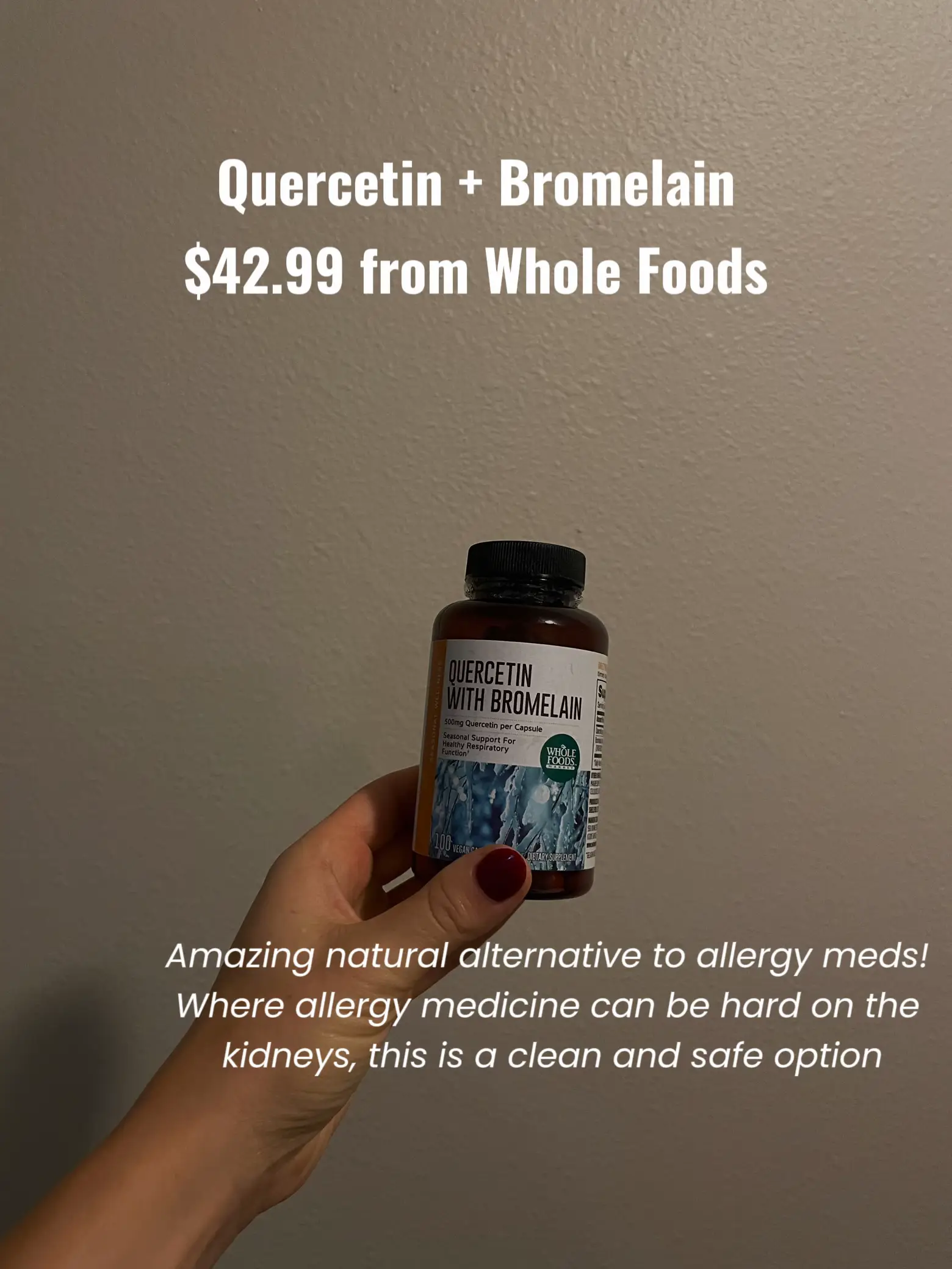  A person is holding a bottle of Quercetin with Bromelain.