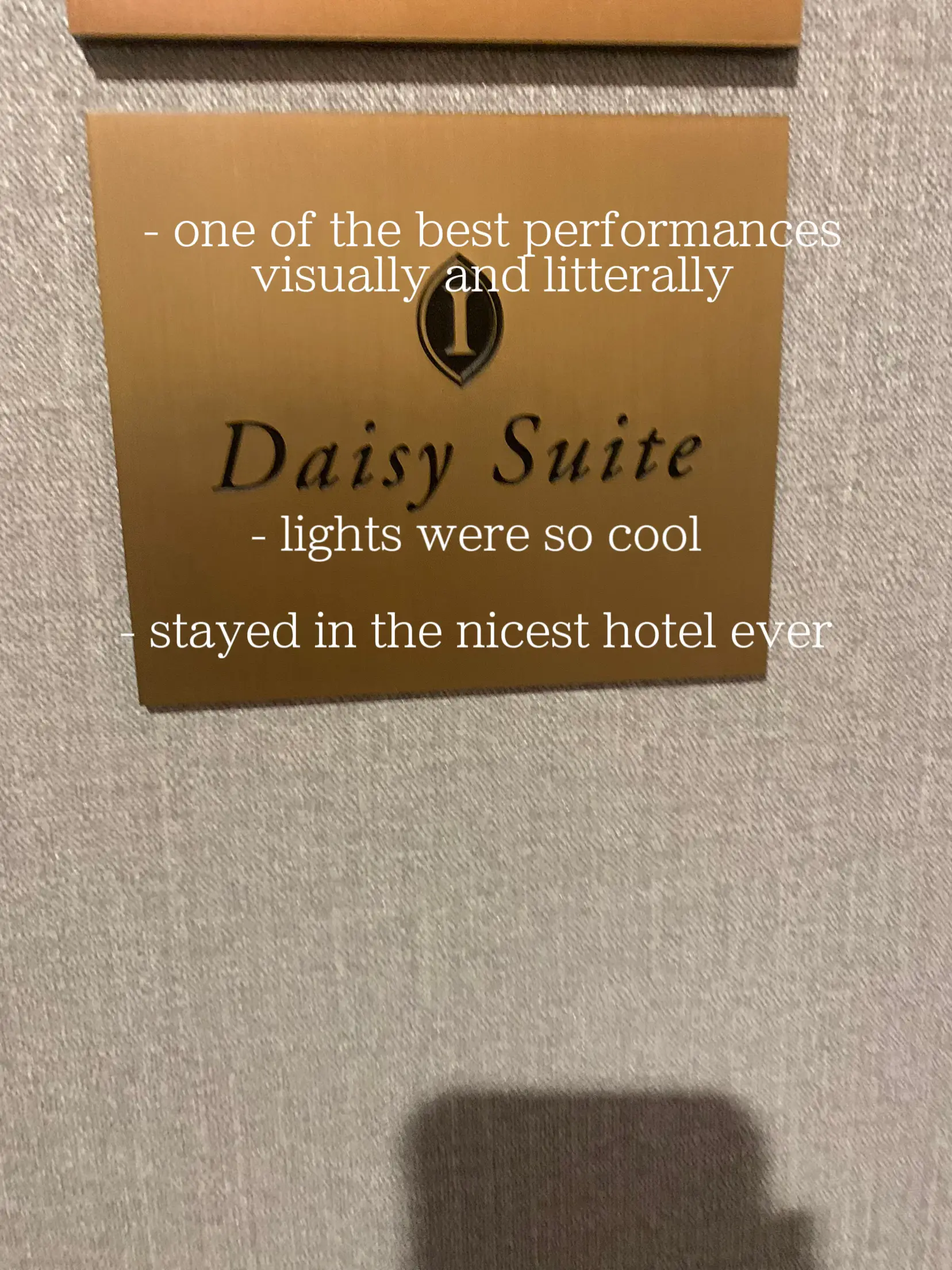  A hotel room with a sign that says "daisy suite".