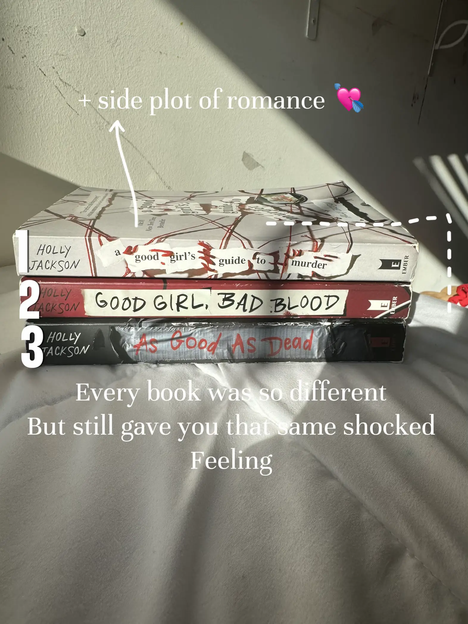  Three books are lined up on a table, with each book having a different title. The books are titled "Holly Good Girl", "Bad Blood", and "As Good As Dead".