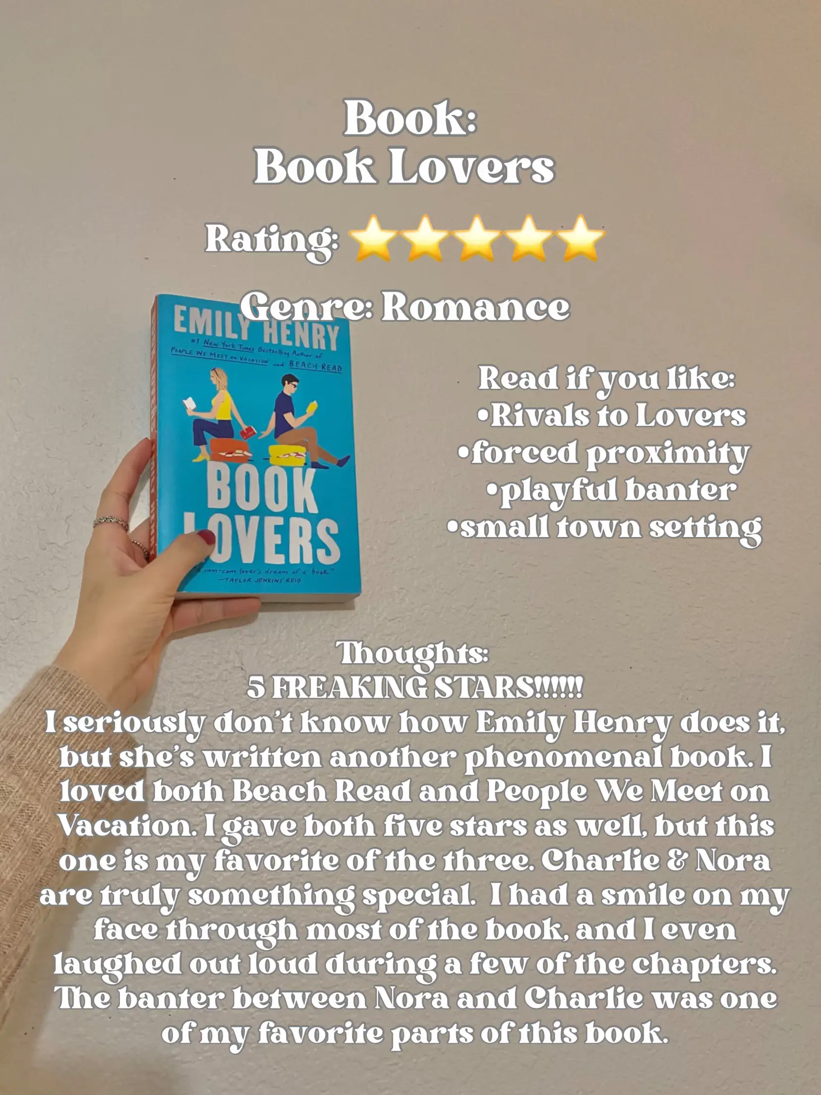  A person is holding a book titled "Book Lovers" by Emily Henry.