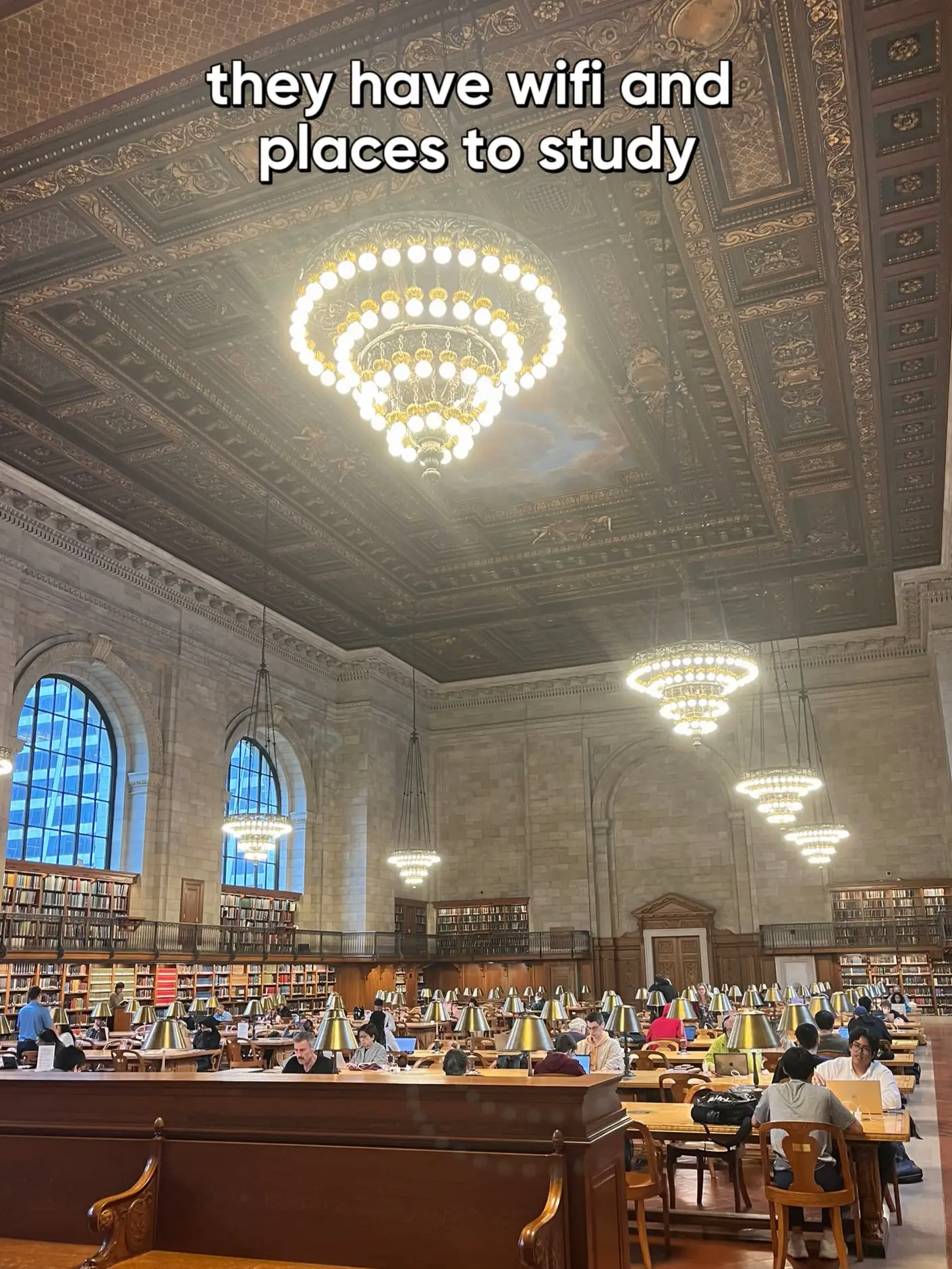  A library with a large number of books and people studying.