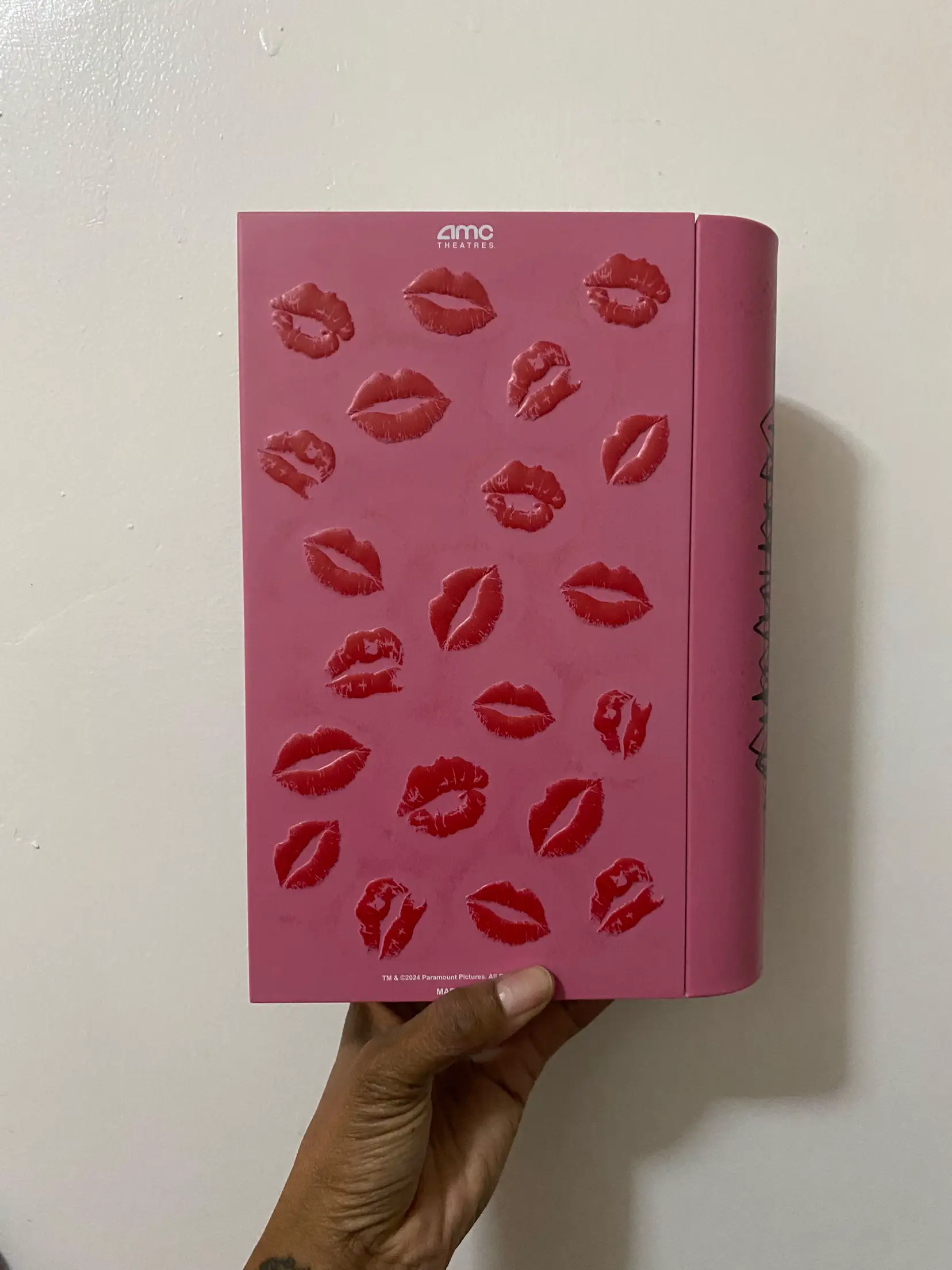  A book with a pink cover and a picture of a kiss on it.