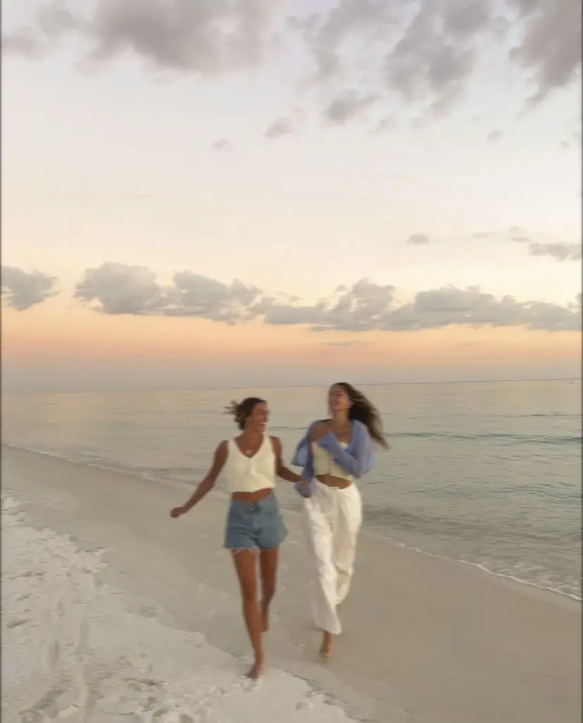  Two women are walking on the beach.