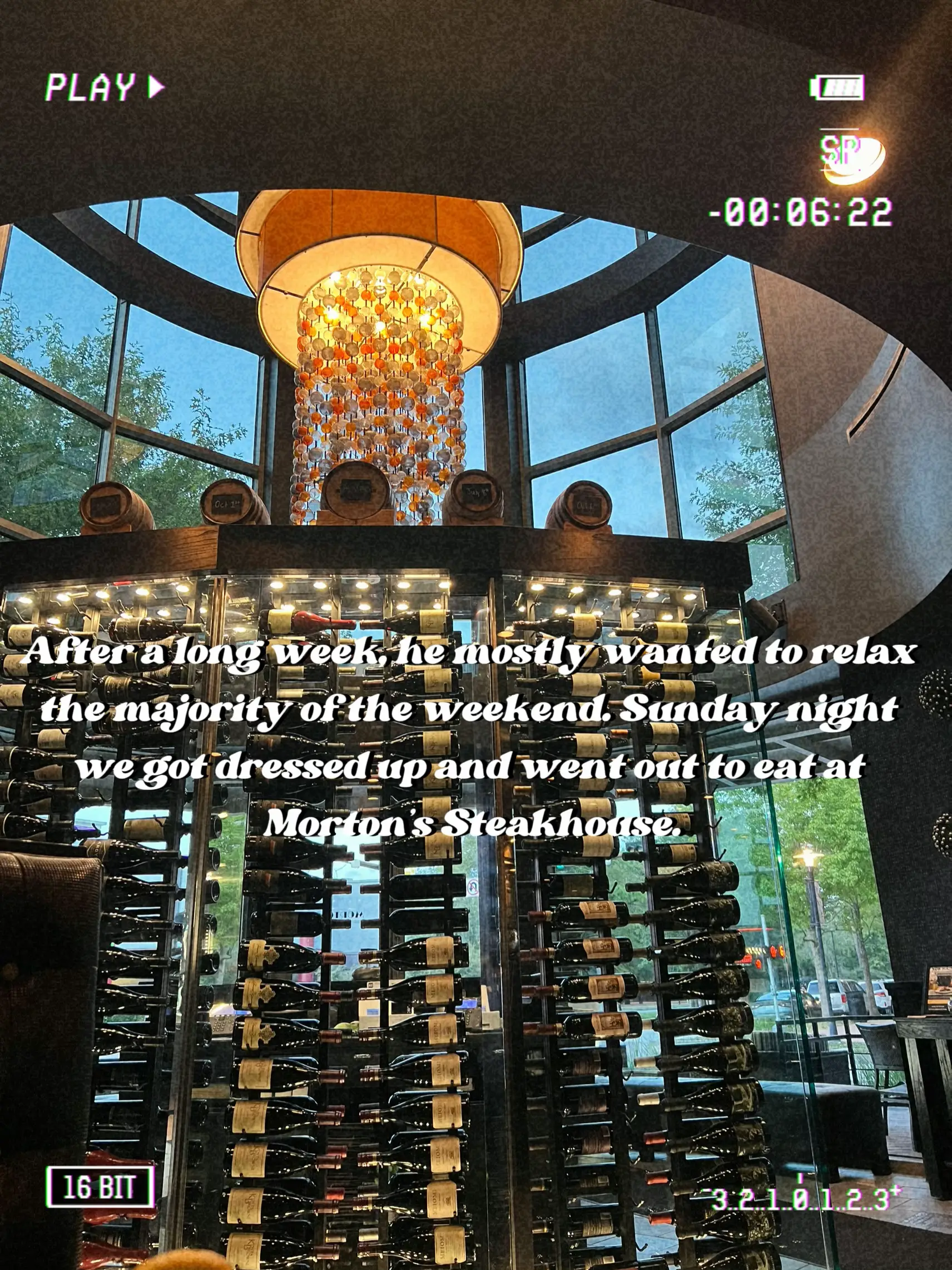  A restaurant with a large number of bottles of wine and a sign that says "after a long week...".