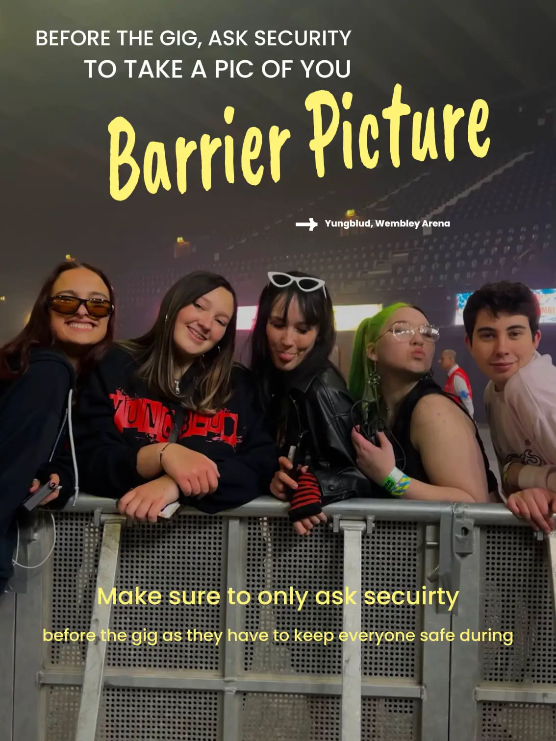  A group of people are standing in front of a barrier