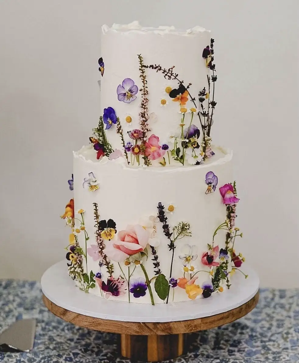  A cake with a white plate and blue flowers on it.