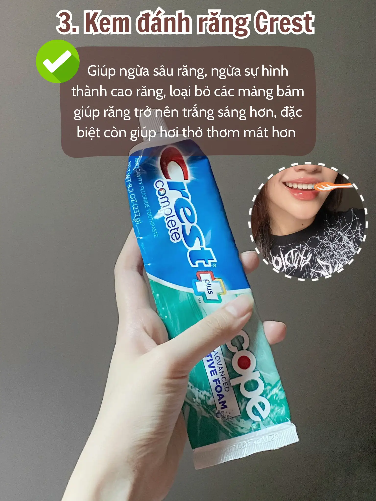  A person is holding a tube of Crest