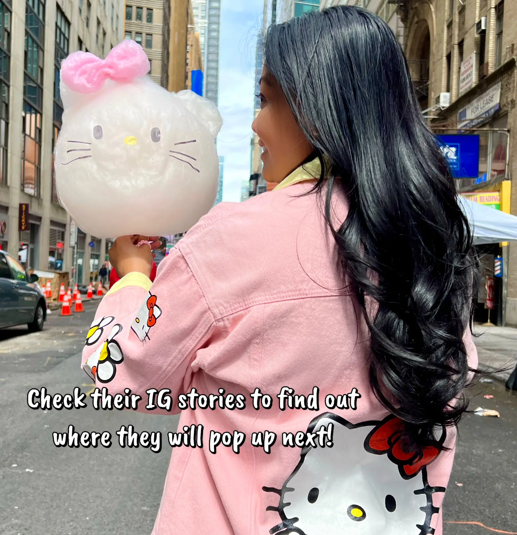  A woman is holding a Hello Kitty phone case.