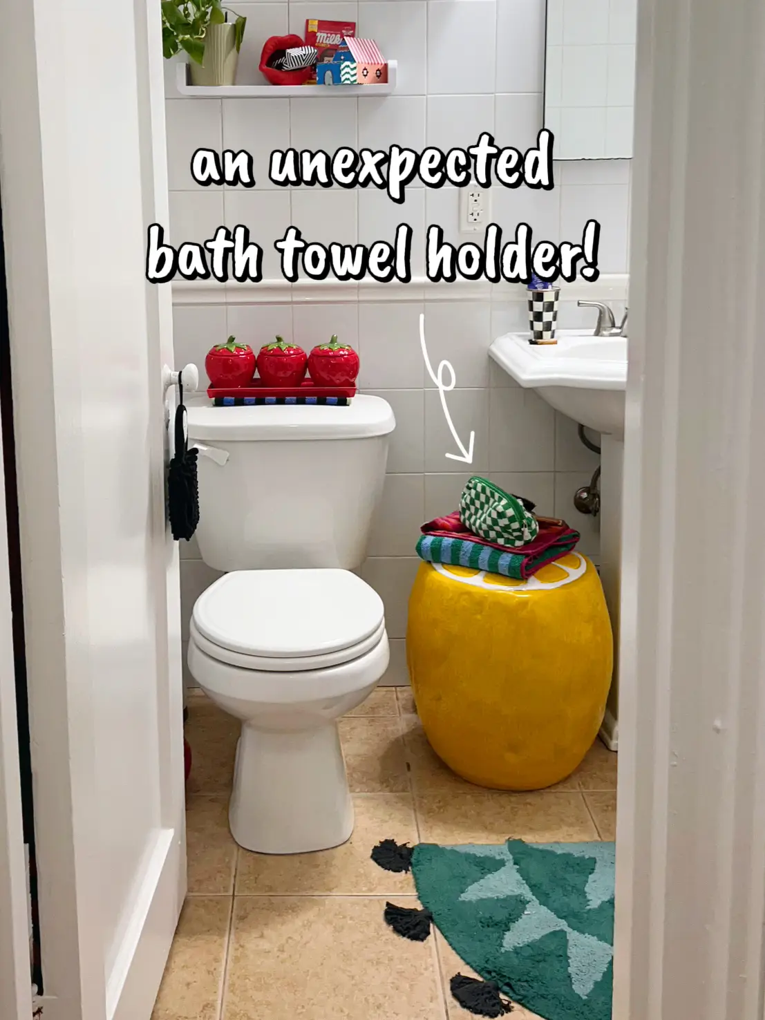  A bathroom with a white toilet and a blue bath towel holder.